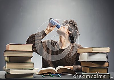 Young man studying and drinking energy drink. Stock Photo