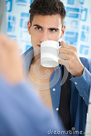 Young man drinking his morning coffee Stock Photo