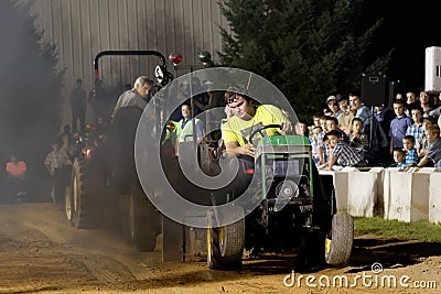 A Young Man Drives at a Lawn Tractor Pull Editorial Stock Photo