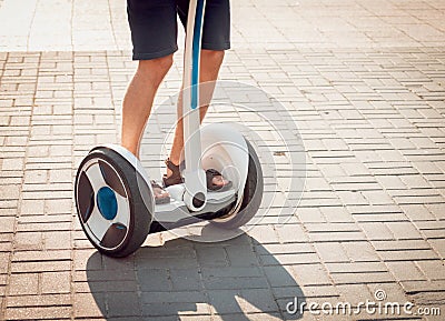 Young man driving on Segway in the park. Stock Photo