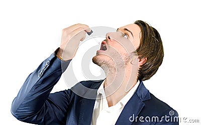 Young man dropping medicine or drug treatment with dropper Stock Photo