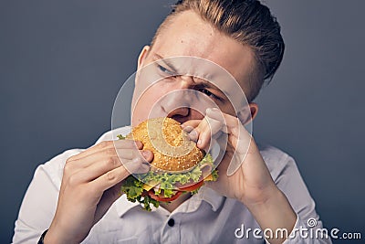 Young man eating a fresh burger Stock Photo