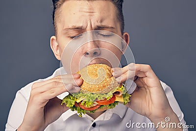 Young man eating a fresh burger Stock Photo