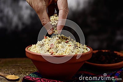 Young man eating tabbouleh with his hand Stock Photo