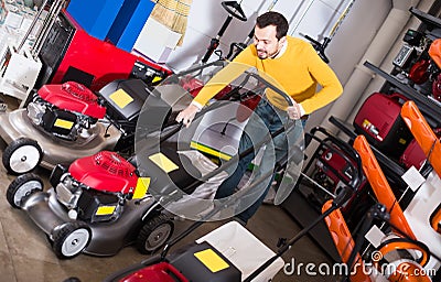 Man elect and tries lawnmowers Stock Photo