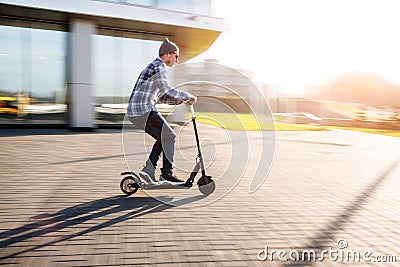 Young man on electric scooter on street Stock Photo