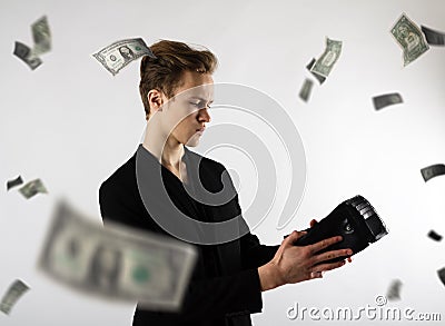 Young man and empty wallet. Currency, expense and income concept. Dollars Stock Photo