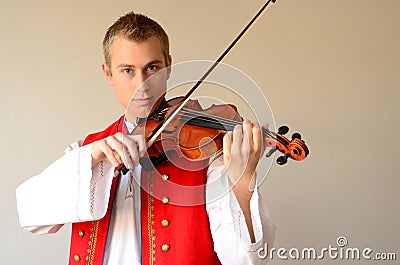 Young man enjoying playing violin Stock Photo