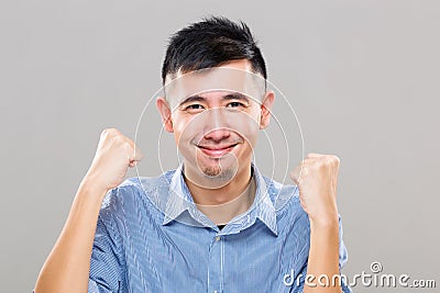 Young man excite to give arm raise fist Stock Photo