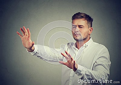 Blind man searching in dark with hands Stock Photo