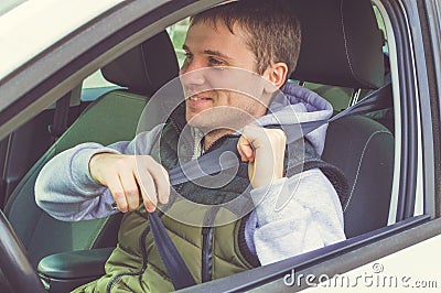 Young man fasten Safety belt. Safe driving Stock Photo