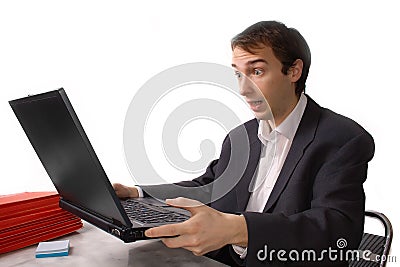 Young man freaks out in front of laptop Stock Photo