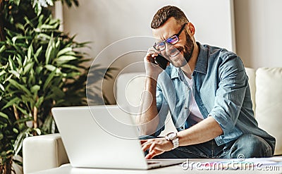 Young man freelancer working at home on a computer Stock Photo