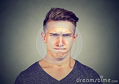 Young man full of hatred looking off and annoyed Stock Photo