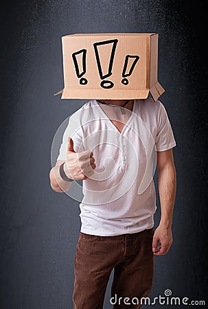 Young man gesturing with a cardboard box on his head with exclamation point Stock Photo