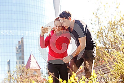 Young man with a girl looking at a smartphone Stock Photo