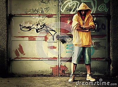 Young man on graffiti grunge wall Stock Photo