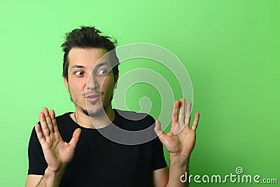 Young man or guy on a light green background. Emotion of detachment Stock Photo