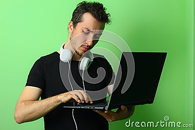 Young man or guy on a light green background. Serious and focused on work Stock Photo