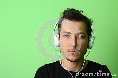 Young man or guy on a light green background. Serious and focused on work Stock Photo