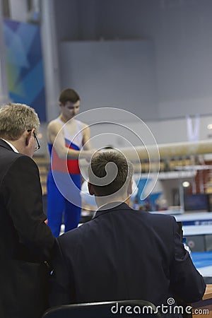 Young man gymnasts preparing in front of judge at the competition Editorial Stock Photo