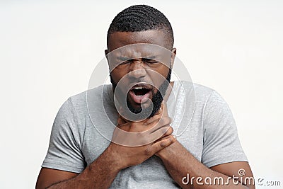 Young man having acute pain in throat Stock Photo