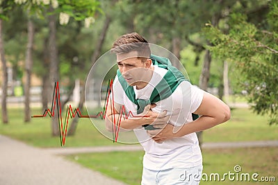 Young man having chest pain outdoors Stock Photo