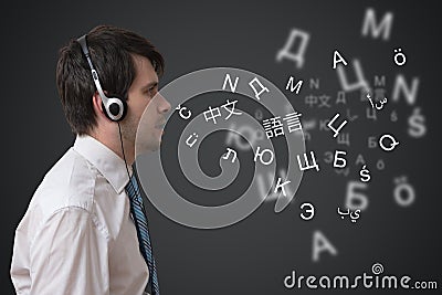 Young man with headphones is speaking in different foreign languages. Stock Photo