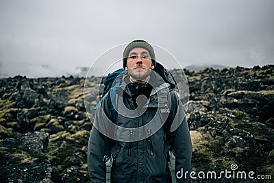 Young man hikes through rough iceland terrain Stock Photo