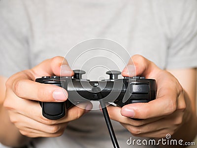 A young man holding game controller playing video games Stock Photo