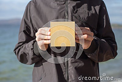 Young man holding a gift box in his hands Stock Photo