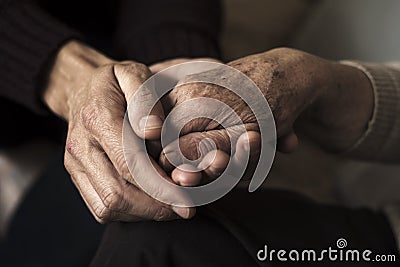 Young man holding the hand of an old woman Stock Photo