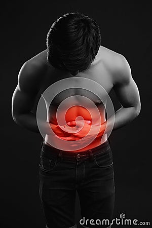Young man holding his sick stomach in pain Stock Photo
