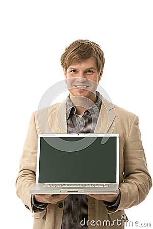 Young man holding laptop with blank screen Stock Photo