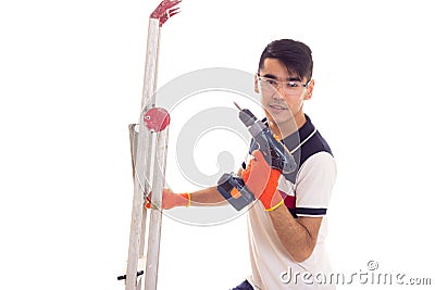 Young man holding ledder and electric screwdriver Stock Photo