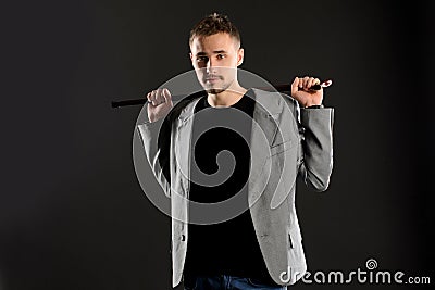 Young Man Holding Walking Stick Behind Himself Stock Photo - Image ...