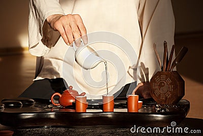 A young man holds a Chinese tea ceremony Stock Photo