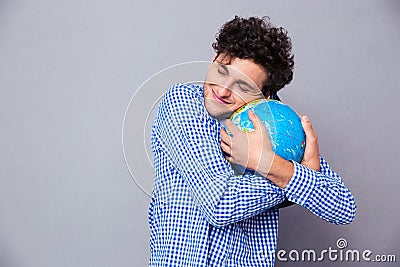 Young man hugging globe Stock Photo