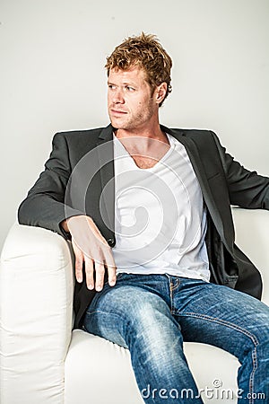 Young man in jeans and dinner jacket Stock Photo
