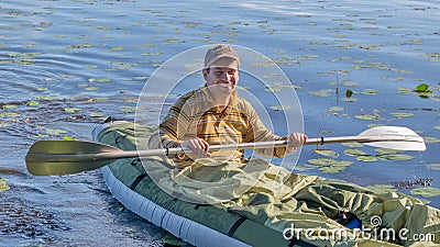 Young man in kayak. Ecotourism, visiting fragile, undisturbed natural areas. Active holidays Stock Photo