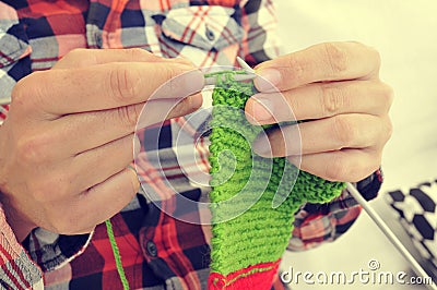 Young man knitting Stock Photo