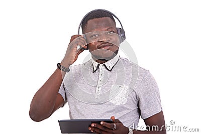 Young man listening to music on headphones with digital tablet Stock Photo