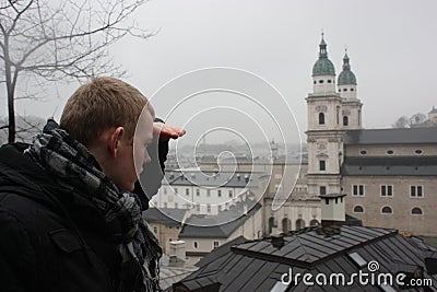 Young man looking above Salzburg town. Stock Photo