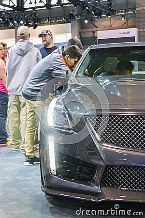 Young man looking at Cadillac`s interior Editorial Stock Photo