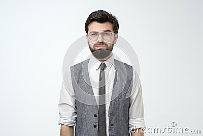 Young man looking camera puffing out cheeks from resentment Stock Photo