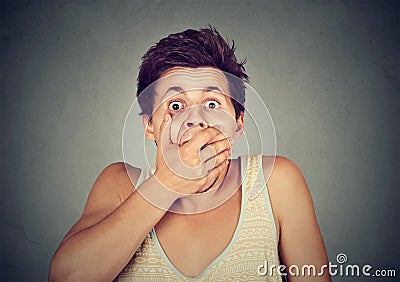 Young man looking shocked scared Stock Photo