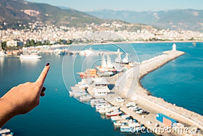 Young man looks at the Alanya port Stock Photo