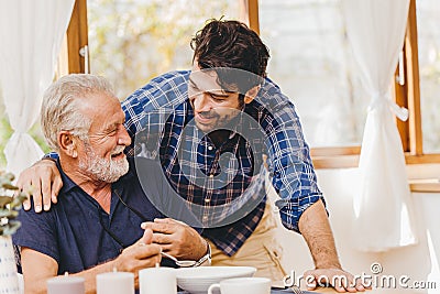 Young man love and care elder eating lunch meal for safe and stay at home happy smile family Stock Photo