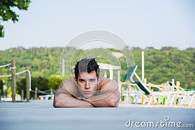 Young Man Lying on Stomach on Sun Deck Stock Photo