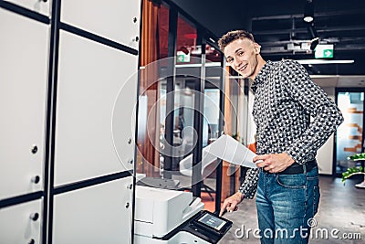 Young man makes copies of documents Stock Photo